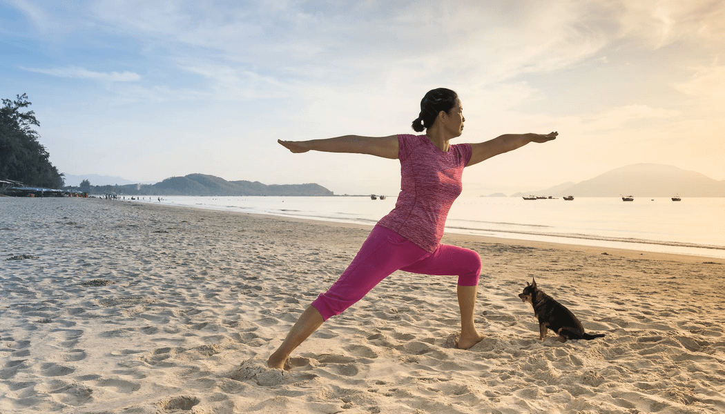 A person practicing yoga on a serene beach