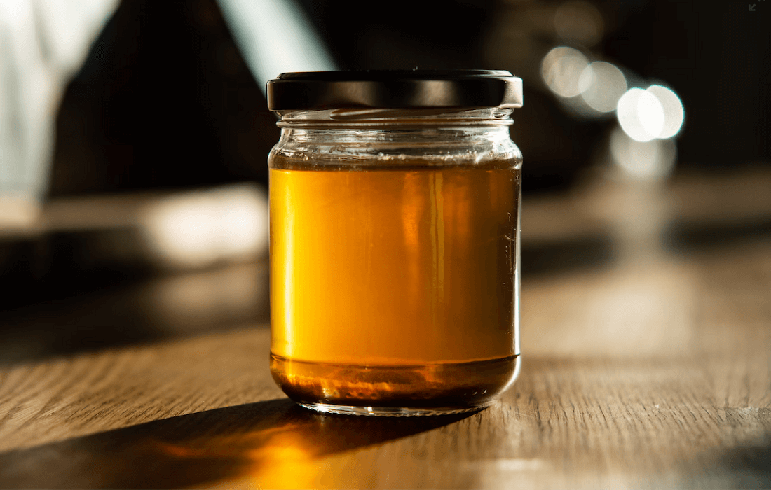 A beautiful jar filled with golden honey