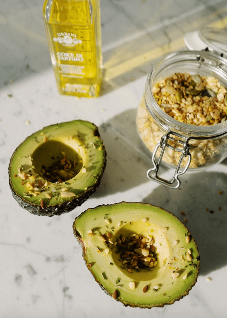 two avocado halfs on kitchen counter