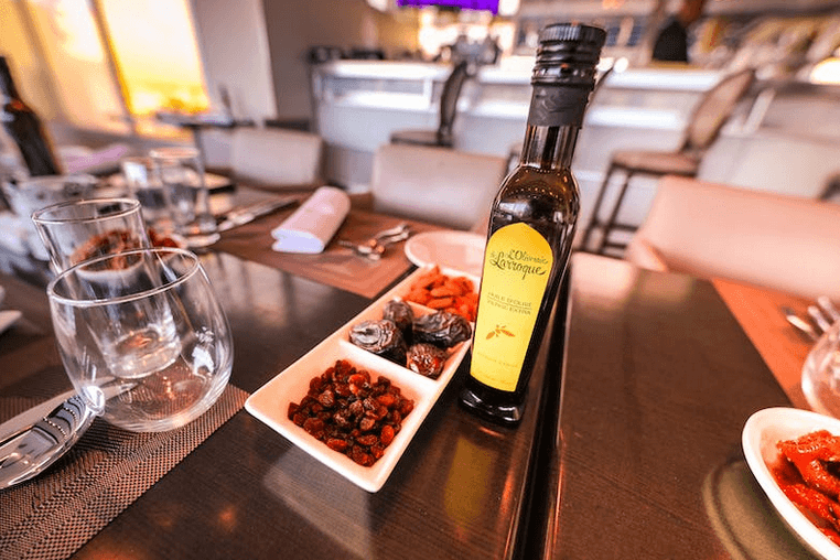 Bottle of extra virgin olive oil on table highlighting health benefits