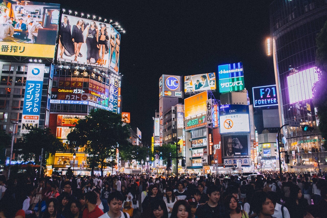 Bustling Shibuya Crossing in Tokyo with neon lights