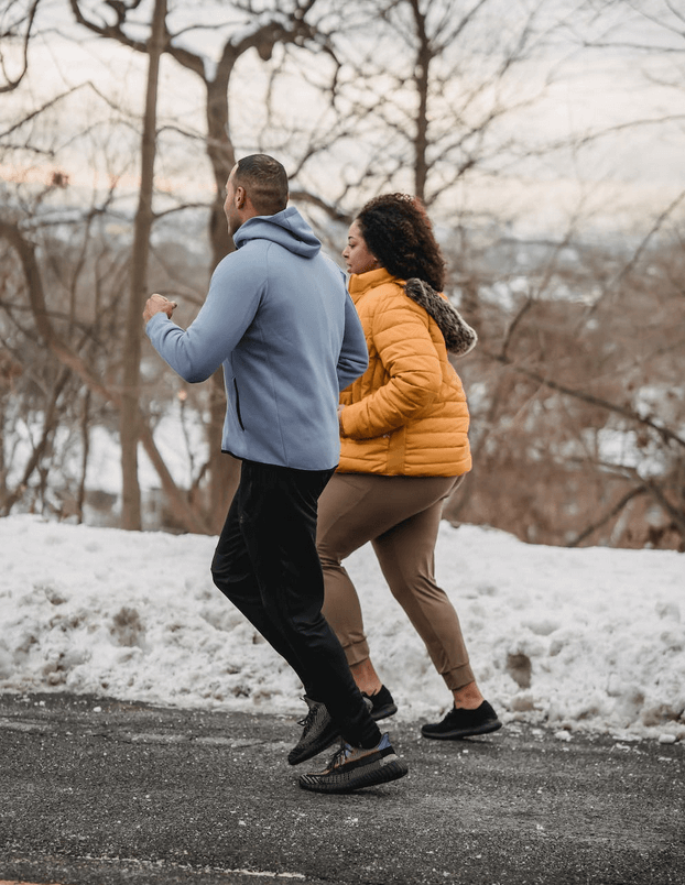 Couple running in snow 